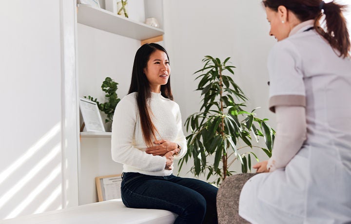 patient speaking with doctor about stomach issue