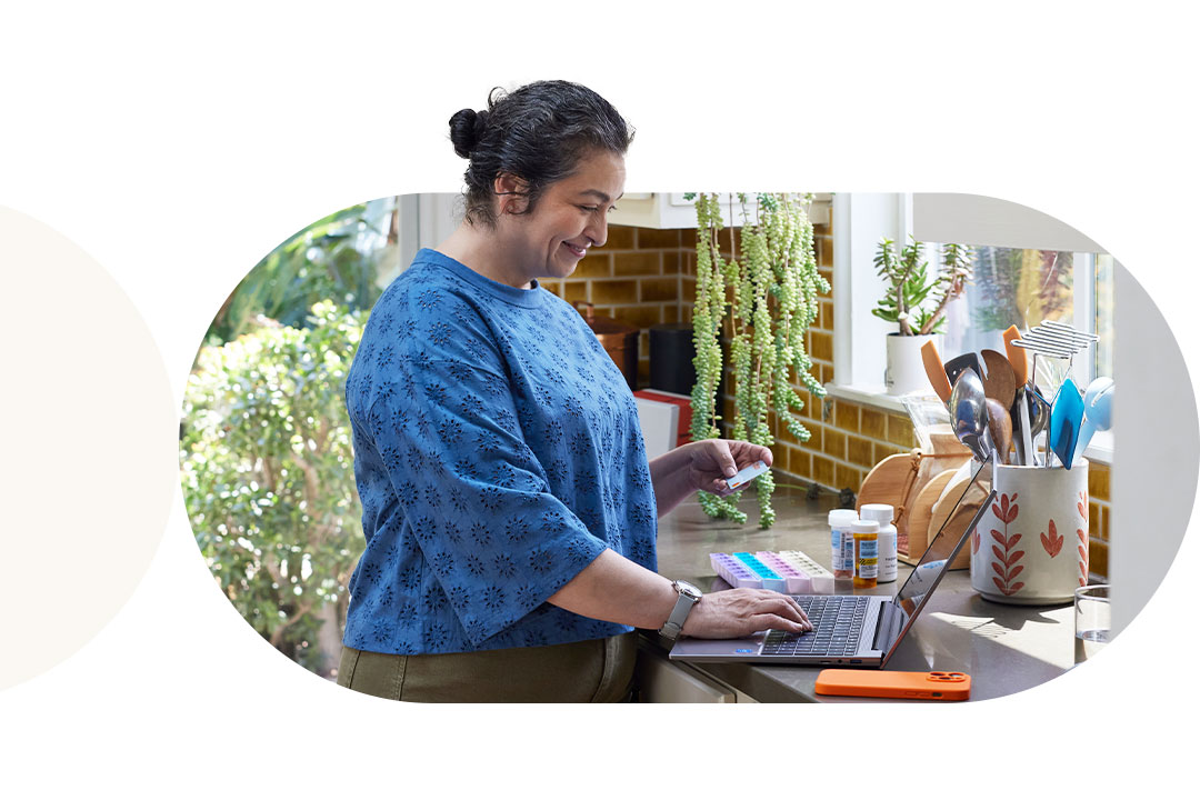 Woman making Rx payment on laptop 